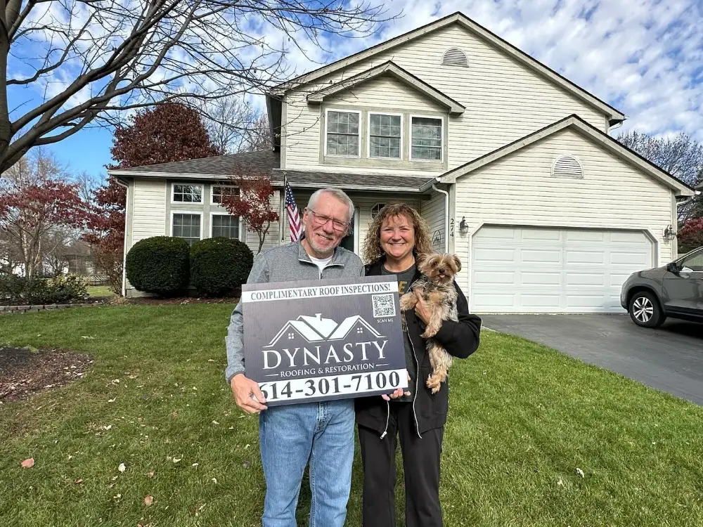 homeowners-with-new-roof homeowners in front of a new roof