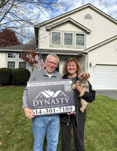homeowners in front of their house with a new roof