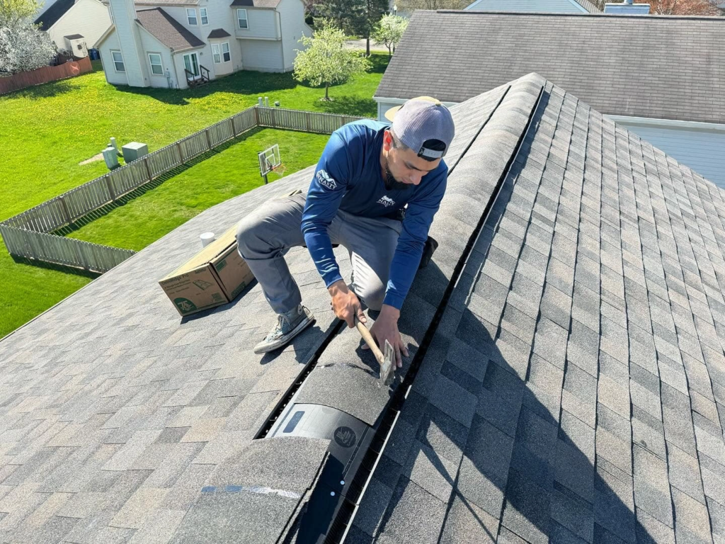 roof-repair roofer repairing the top of a roof
