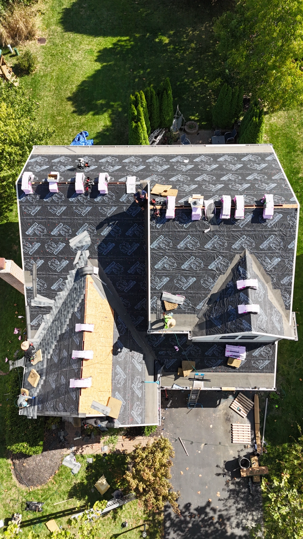 roof-replacement-process top view of a roof being replaced with shingles