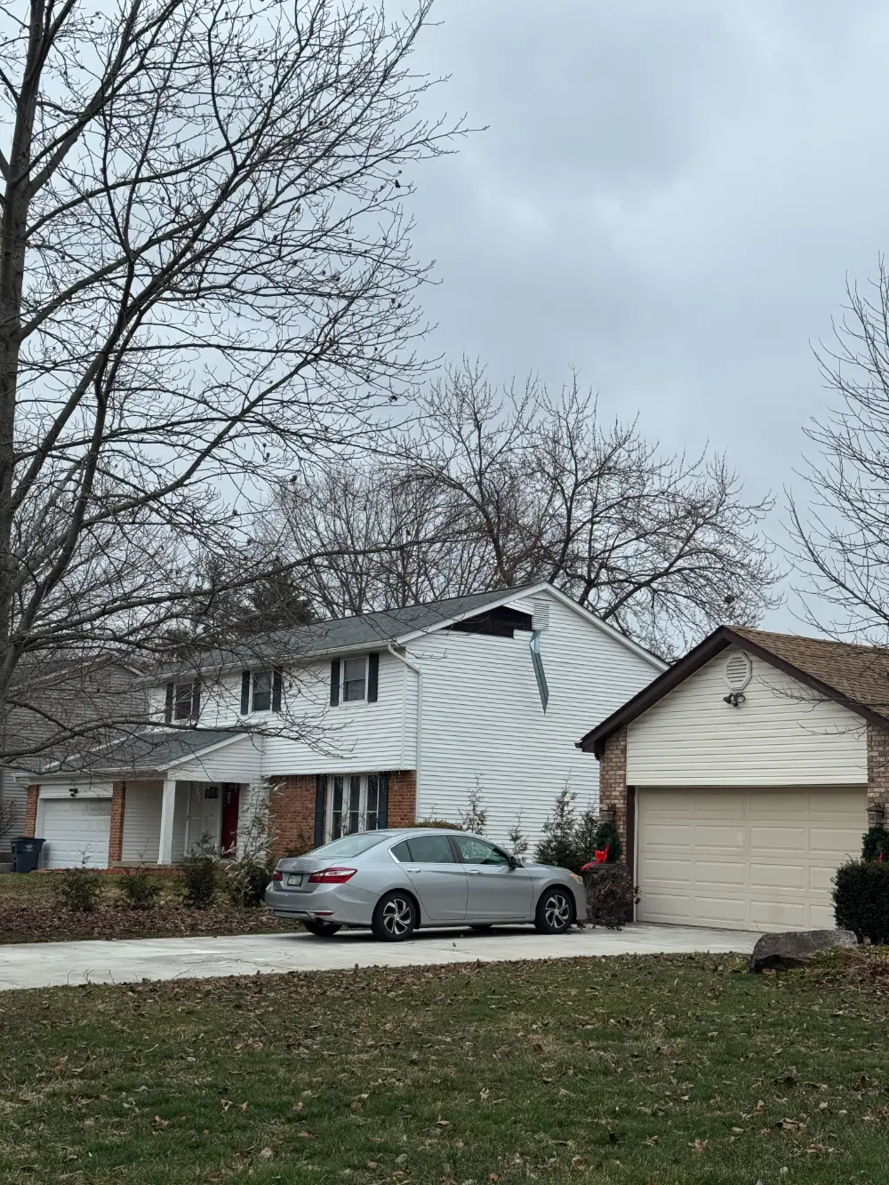 siding-falling-apart siding that has fallen off a house due to a storm