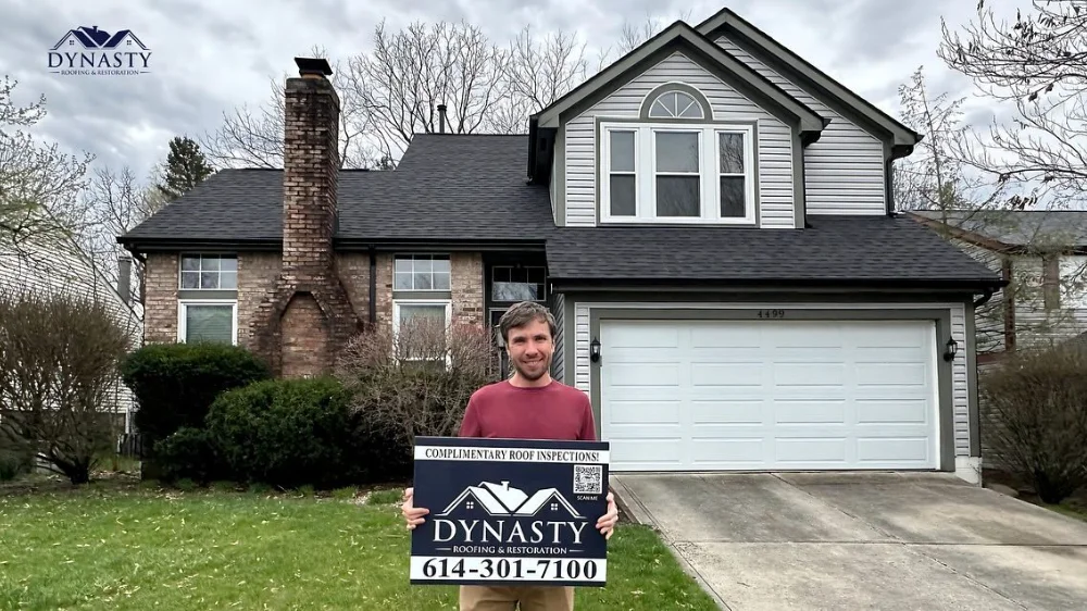 reynoldsburg-gutter-installation homeowner standing in front of his reynoldsburg home with new gutters