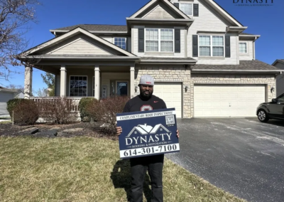 happy homeowner in front of their new albany home with a new roof