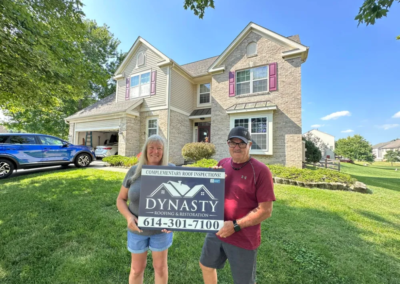 happy homeowner in front of their home with new siding in pataskala