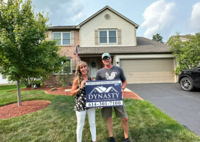 happy homeowner in front of their home with new roof in pataskala