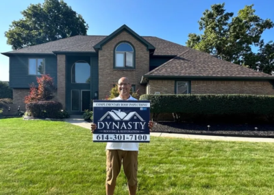 happy homeowner in front of their home with new gutters in pataskala