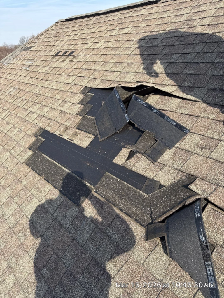 a roof at the end of it's life span with shingles missing